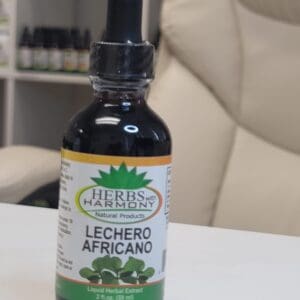 A bottle of herb essence sitting on top of a table.